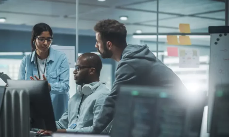 A group of people working on computers in an office.