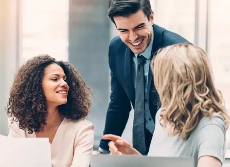 A group of venture capitalists laughing at a meeting.