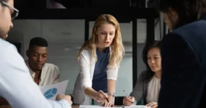 A group of business people sitting around a table.